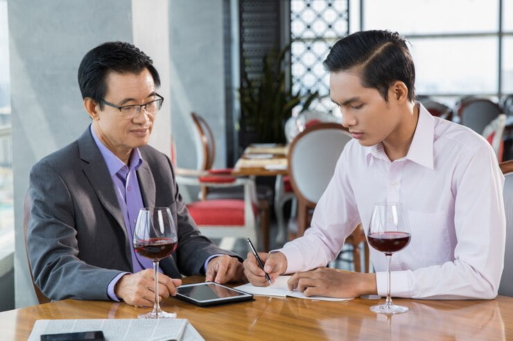 two-businessmen-discussing-project-restaurant_1262-1645 - Winz Credit licensed money lenders